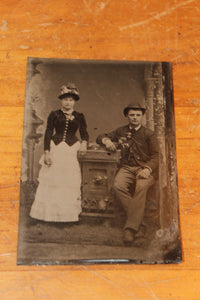 Old tin type photo of a man and a woman
