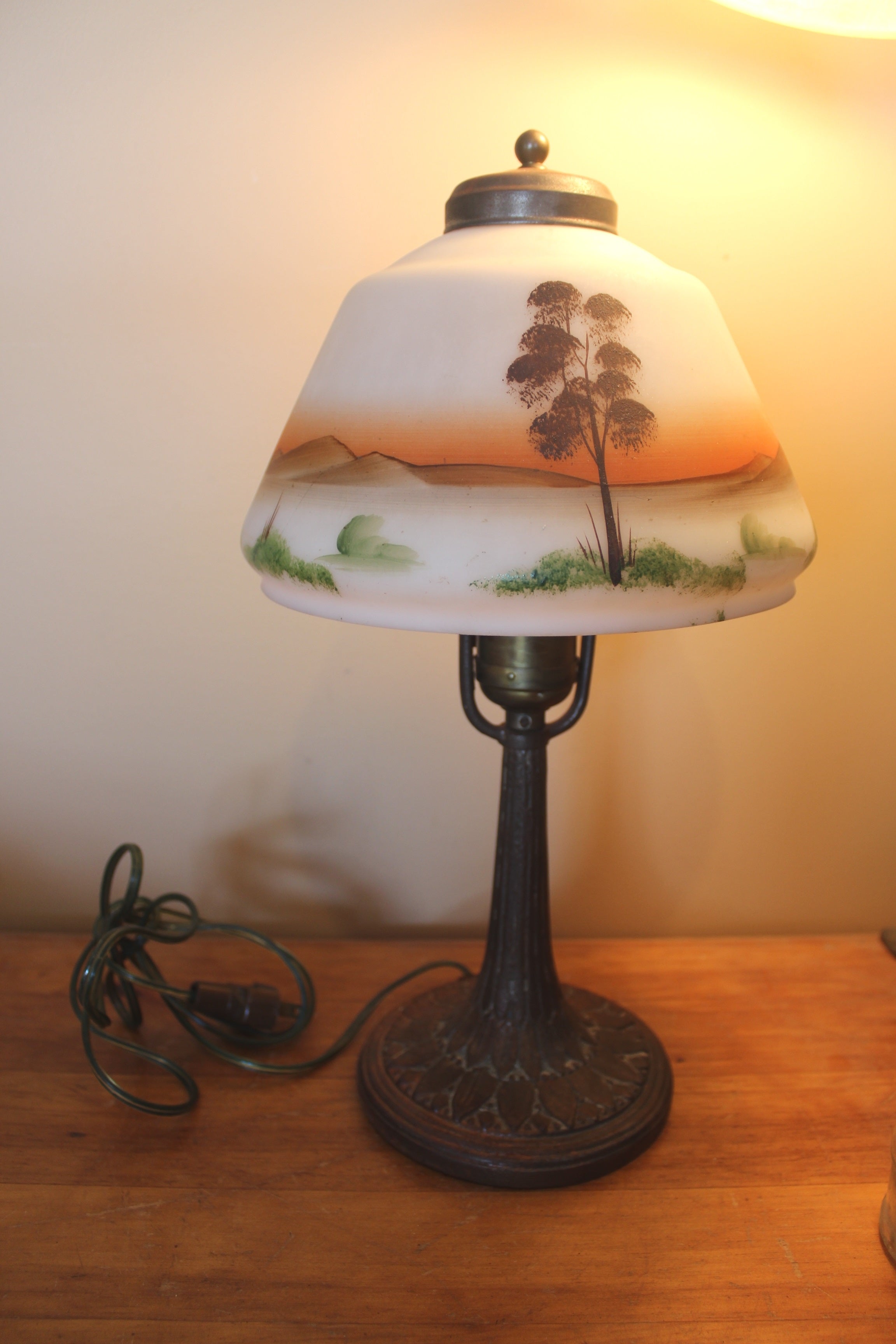 Old metal lamp with decorative glass shade
